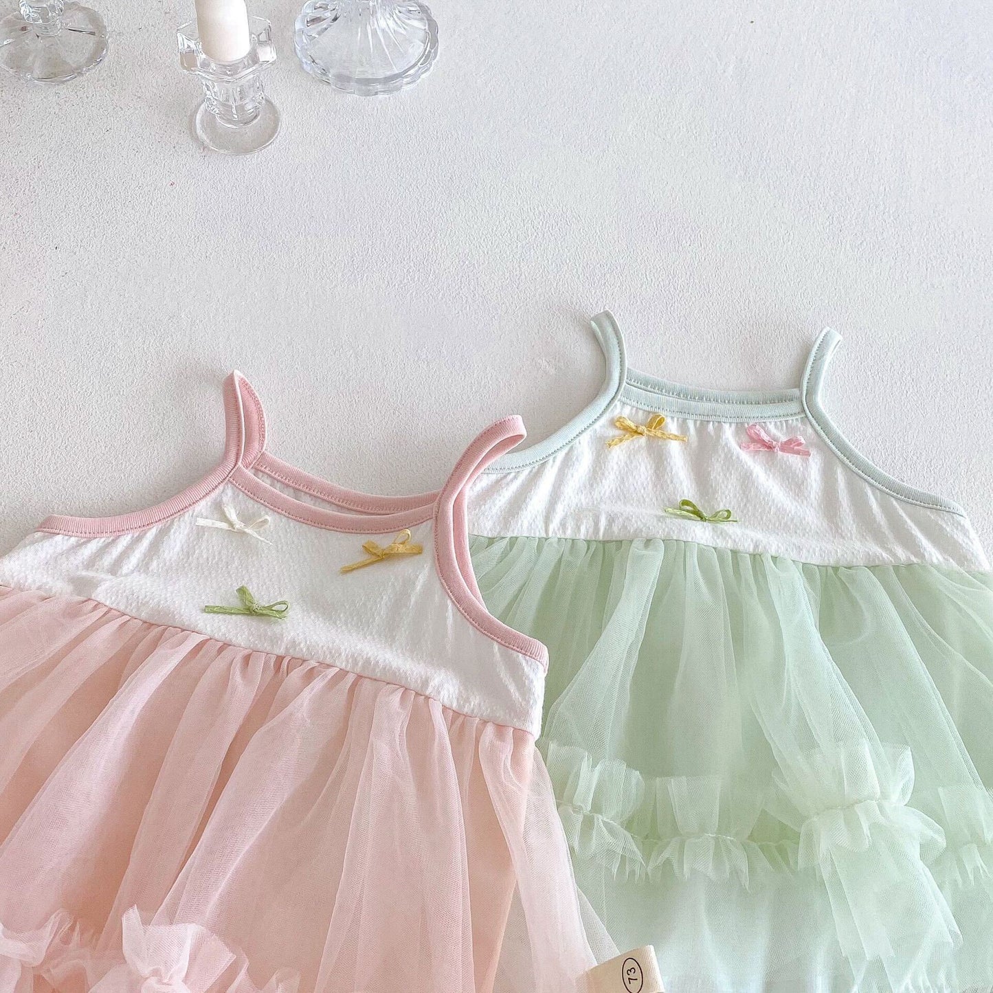 Bow knot ruffle net premium romper