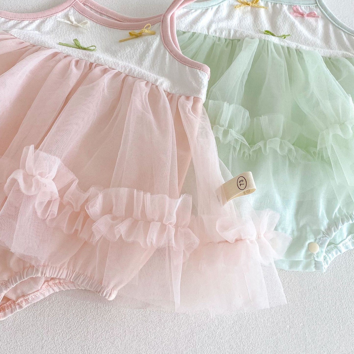 Bow knot ruffle net premium romper