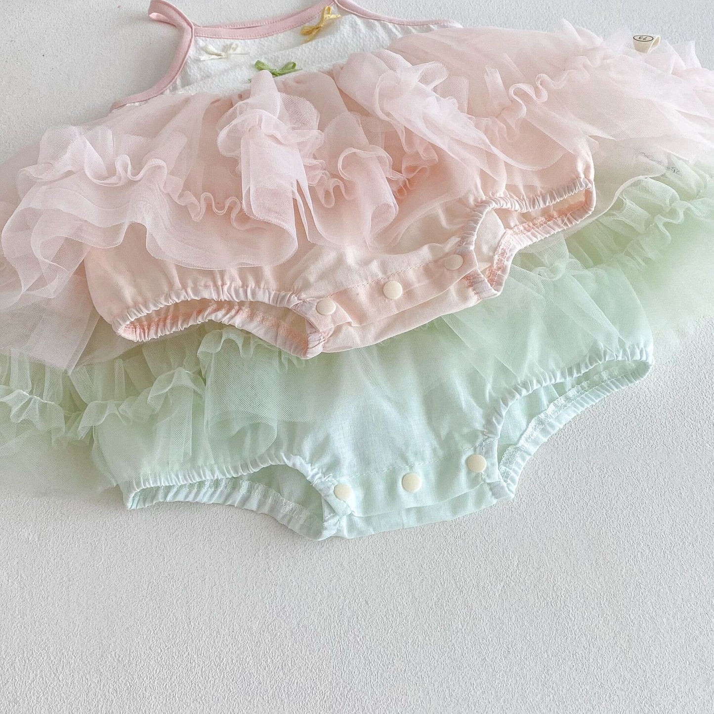 Bow knot ruffle net premium romper